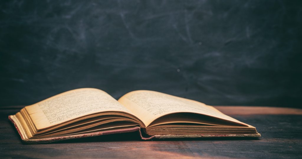 Vintage book on blackboard background